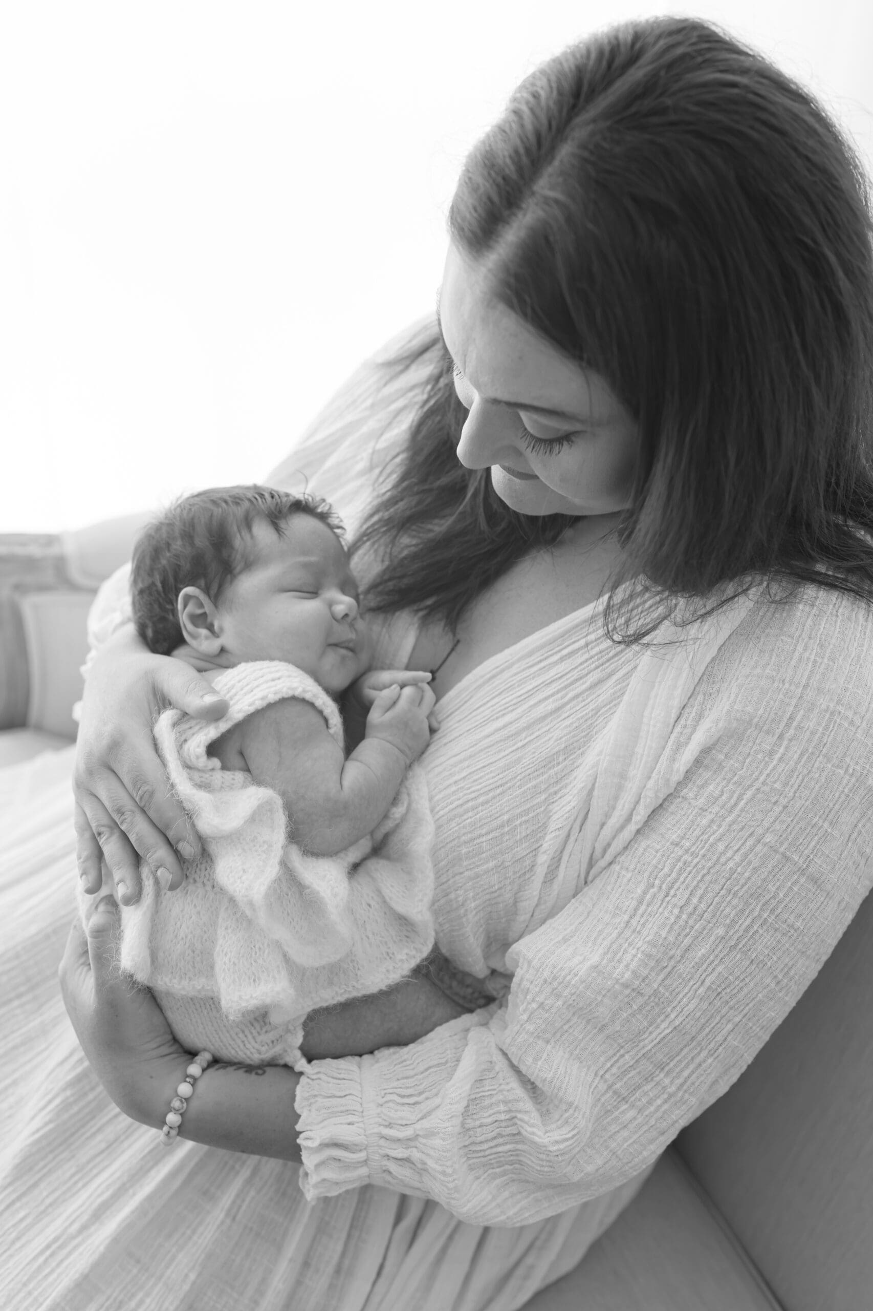 Alliston newborn photographer captures parents and siblings in bright studio setting

